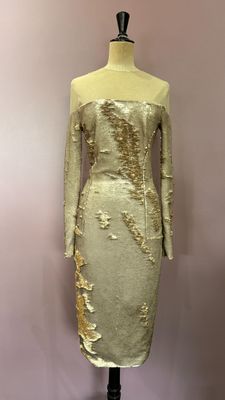 a mannequin dress with gold sequins on a mannequin mannequin