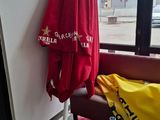 a red and yellow umbrella sitting next to a window