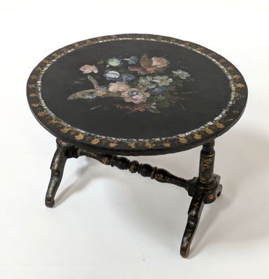 a black table with flowers on it on a white background
