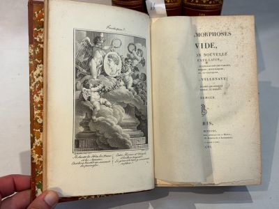 a hand holding an open book with a picture on it