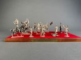 an image of a group of figurines of soldiers on a red surface