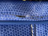 a close up of a piece of blue fabric with a hole in it