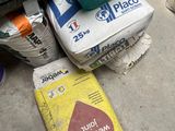a container of water sitting on top of a pile of cement