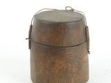 a small wooden box with a handle on a white surface