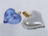 pair of blue and silver heart shaped cufflinks on a white background