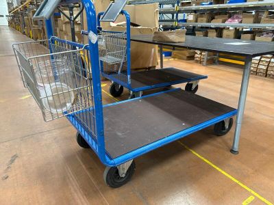 a shopping cart that is sitting on the floor in a warehouse