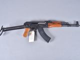 a close up of a gun on a table with a tag on it
