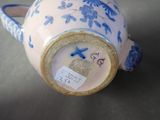 a blue and white vase with a bird on it