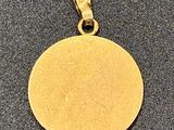 a close up of a gold coin on a black surface