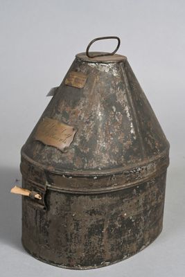 an old metal container with a tag on it