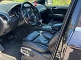 the interior of a car with the door open and the driver ' s seat down