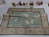 a table with a table cloth on it that has a lot of items on it