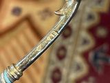 a close up of a metal arrow on a rug