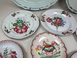 many plates with flowers on them on a table
