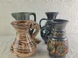 two vases sitting next to each other on a table
