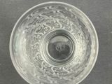 a glass bowl with a black and white image of a bird