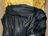 a box with a black jacket and a yellow shirt in it