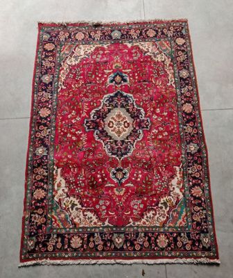 a red rug with a medallion design on it