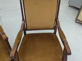 pair of antique wooden chairs with upholstered upholstered arms