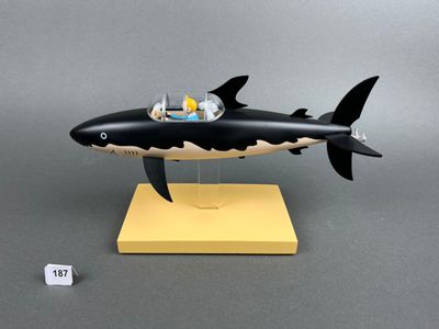 figurine of a shark with a man in a boat on its back