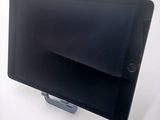 a tablet that is sitting on a stand on a table