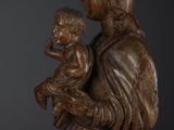 an image of a wooden statue of a woman holding a child