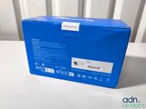 the box is open on a white table with a white chair in the background