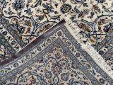 a close up of a rug with a piece of fabric on top of it