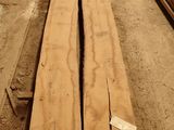 several pieces of wood are stacked on top of each other in a warehouse