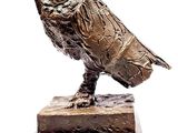 a statue of a bird that is sitting on top of a base