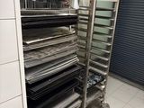a metal rack that has many trays of food on it