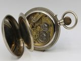 an antique silver pocket watch with a chain hanging from it ' s side