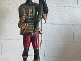 a statue of a man holding an umbrella on a pedestal