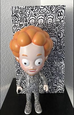 a toy that is sitting on a table near a picture