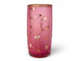 pink vase with gold and white flowers on it on a white surface