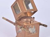 une petite boîte en métal surmontée d'un miroir