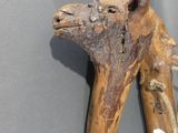 a wooden animal head on a piece of wood