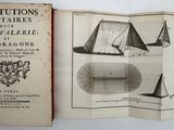 a book opened to show a picture of a sailboat and other boats