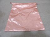 a pink bag that has a gold logo on it