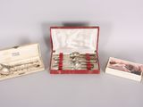 three silverware items in a red case on a table