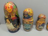 three nesting dolls are lined up in a row on a white surface