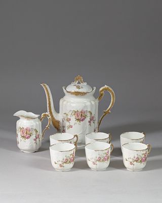 five cups and a teapot on the table
