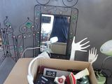 a cardboard box filled with assorted items and a mirror