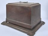 a small wooden box with a handle on a stand