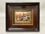 a painting of a village scene in a wooden frame