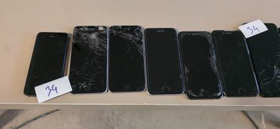 four iphones are sitting on a table with a price tag on them