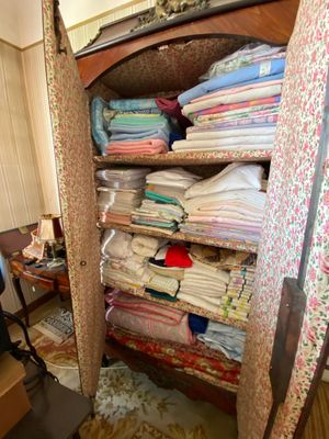 a closet full of clothes and a chair in a room