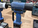 two electric tools on a table in a room