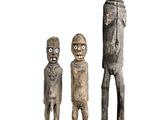 three wooden figurines of a man and a woman standing next to each other