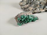 a piece of rock with a green substance on top of it